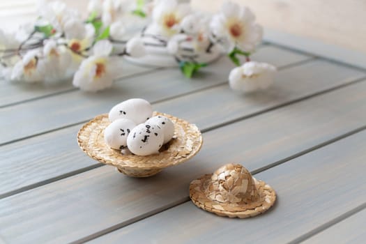 Straw hat decorated for easter with flowers and easter eggs for spring decoration