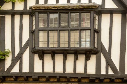 view of bow window of old house built in wattle in the historic village.