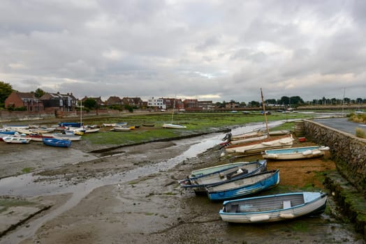 view of the touristic sea village  with boats aground at low tide time .