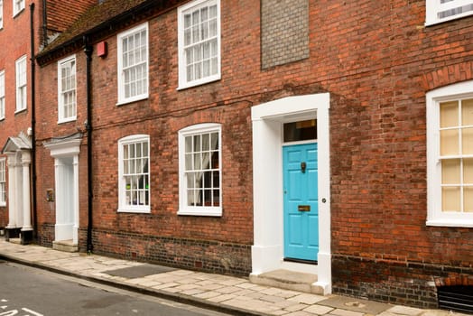 view of street with Georgian classic residential buildings in town center, Chichester, West Sussex.
