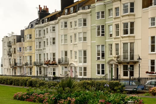 foreshortening of facades of old houses on an uphill street in touristic sea town,  Brighton, East Sussex.