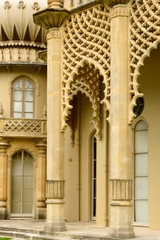 view of columns of highly decorated building in center of touristic sea town, shot from the public street,  Brighton, East Sussex.