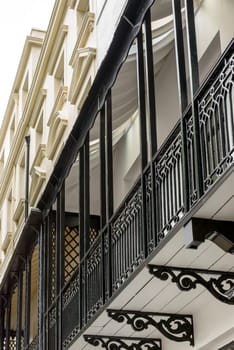 detail of balcony railing made in cast-iron  in center of touristic sea town, shot from the public street,  Brighton, East Sussex.