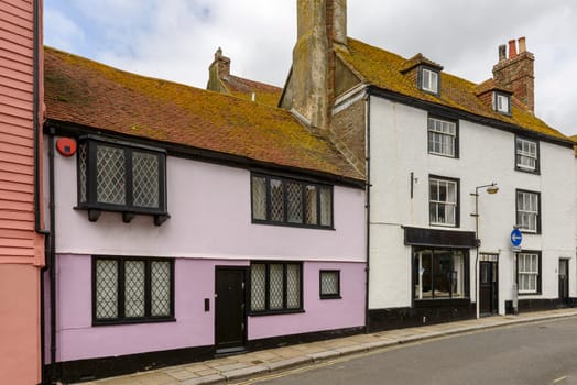 view of old houses on a street in the historic village of Hastings, East Sussex .