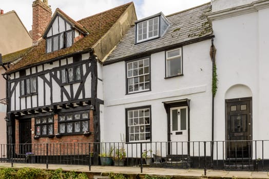 view of old houses in stone and wattle on a street in the historic village of Hastings, East Sussex .