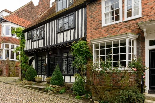 view of old brick and wattle houses on a street in the historic village of Rye, East Sussex .