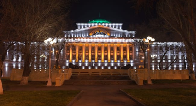 Rostov-on-Don,Russia-November 30,2013:Building the Bank of Russia lit decorative illumination.In the foreground is a statue of a lion. Near bank there are cars