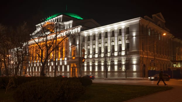 Rostov-on-Don,Russia-November 30,2013:Building the Bank of Russia lit decorative illumination.In the foreground is a statue of a lion. Near bank there are cars