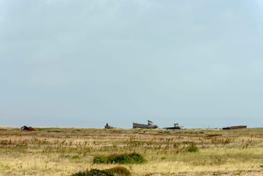 view of  wrecks of old fish boats on the seaside at Dungedness,  Romney Marsh, Kent.