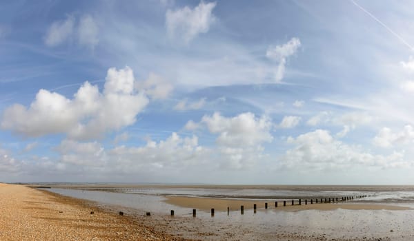 view, at low tide time, of the sea and the shingle beach at New Romney, Kent.