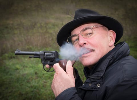 Man aiming a gun Nagan.