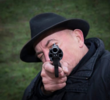 Man aiming a gun Nagan.