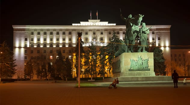 Rostov-on-Don,Russia-November 30,2013:Building the Bank of Russia lit decorative illumination.In the foreground is a statue of a lion. Near bank there are cars