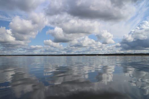 gorgeous cloudy landscape cumulus clouds are reflected in the water surface of the lake a soothing relaxing landscape