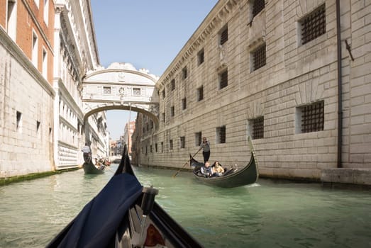 Venice, Italy, March 30, 2014: The gondolier floats on a gondola with tourists