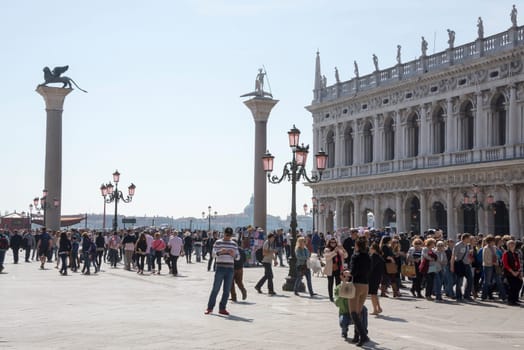 VENICE,ITALY-MARCH 30-Tourists walk on the Piazza San Marco  in March 30,2014 in Venice