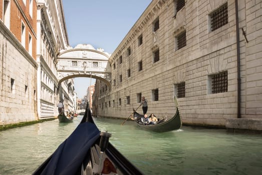 Venice, Italy- March 30, 2014: The gondolier floats on a gondola with tourists