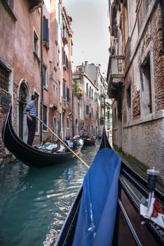 Venice, Italy- March 30, 2014: The gondolier floats on a gondola with tourists