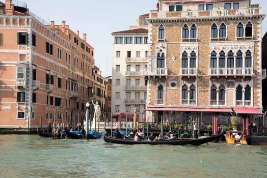 Venice, Italy- March 30, 2014: The gondolier floats on a gondola with tourists