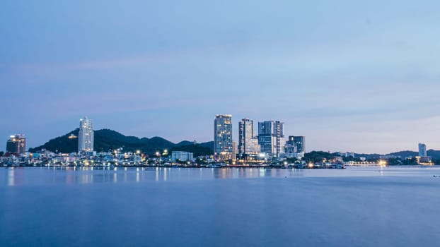 Panorama scenic of seascape with building on background and small mountain at dusk in Sriracha Chonburi Thailand