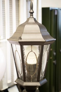 Classic metal black street lamp post with LED lightning close up