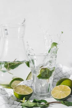 Detox water with lime fruit and mint leaves. Mint fresh homemade lemonade.