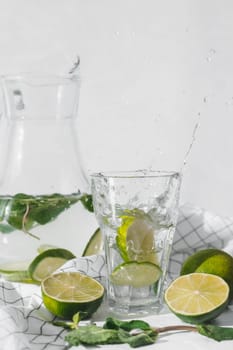 Detox water with lime fruit and mint leaves. Mint fresh homemade lemonade.