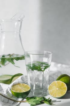 Detox water with lime fruit and mint leaves. Mint fresh homemade lemonade.