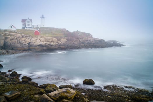 Long exposure image of Nubble lighthouse in York, ME in dense fog