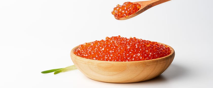 Red caviar in a wooden cup on a white background with a spoon. Place for advertisement, logo, label, mockup, mock-up.