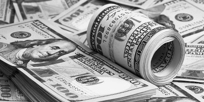 A hundred American banknotes are scattered. cash hundred-dollar bills, dollar background image.