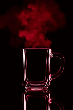Just a glass on a black background with a reflection. Red color, with steam. Isolated.