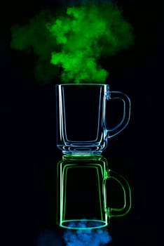 Just a glass on a black background with a reflection. Blue and green, with steam. Isolated.