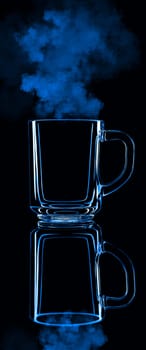 Just a glass on a black background with a reflection. Blue color, with steam. Isolated.