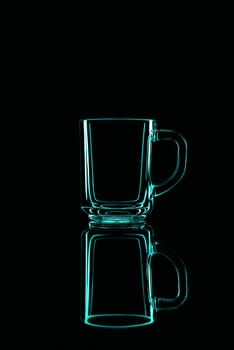 Just a glass on a black background with a reflection. Green colors. Isolated.