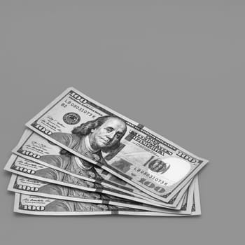 A wad of hundred-dollar cash fanned out on a gray background. A place for a label, mockup, mock-up.