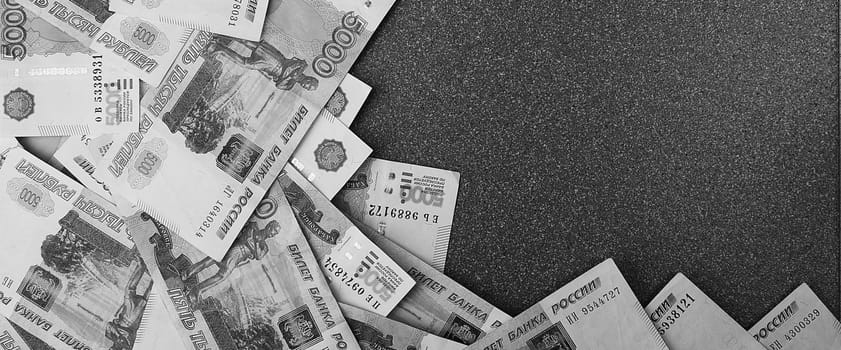 Russian cash banknotes of five thousand rubles, scattered on a gray background, there is a place for the inscription and text. Layout, layout.