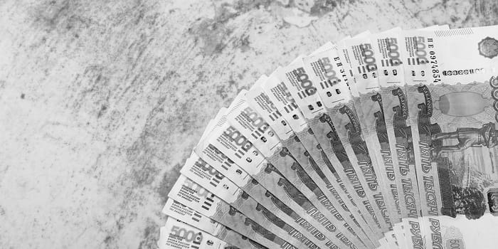 Russian money banknotes of five thousand rubles, background, banknotes are arranged in a fan on a gray background. Layout, mockup.