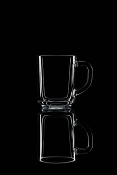 Just a glass on a black background with a reflection. Isolated.