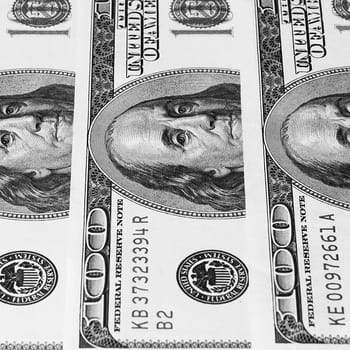 Banknotes of dollars are stacked in a row, background.
