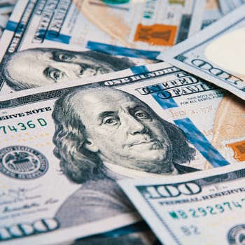 A hundred American banknotes are scattered. cash hundred-dollar bills, dollar background image.