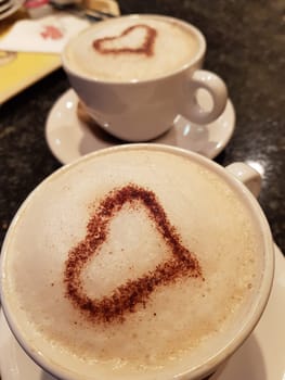 A cup of coffee on dark blurred background with motion blur. For example, a company name could easily be pasted on behind the cup.