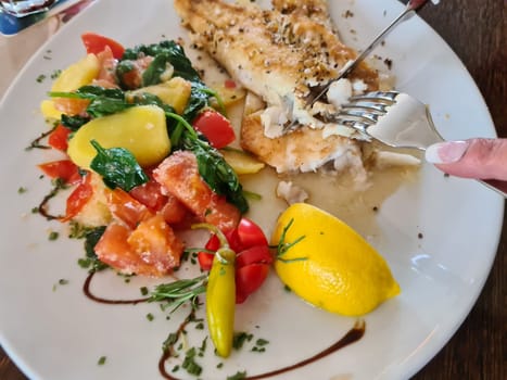 Pike perch fillet with asparagus, broccoli and carrots. Fried fish with stewed greens.