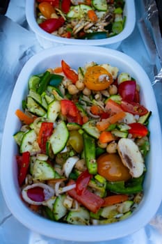 Grilled vegetables ( colorful bell pepper, zucchini, eggplant ) with basil and dry herbs on a plate over dark slate, stone, concrete or metal background.Top view.