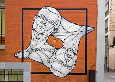 Collage deux têtes d'hommes sur un mur de Paris (France)