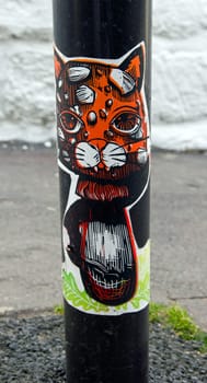 Cat collage street art in a street of Paris (France).
