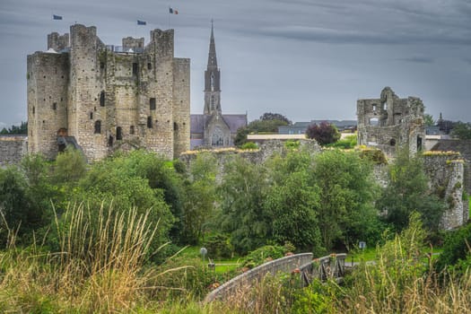 Old, ruined Trim Castle and St Patricks Catholic Church in the background in Trim village, County Meath, Ireland