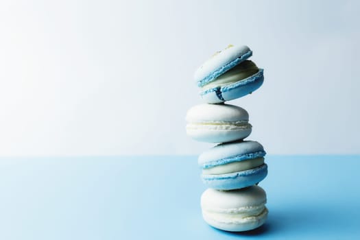 White and blue macaroons on the table, macaroons on white blue background. High quality photo