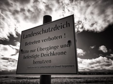 Warning sign on protective dike, Mecklenburg Baltic Sea coast