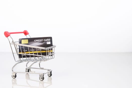 Credit card in shopping cart for online shopping on white, Work from home concept